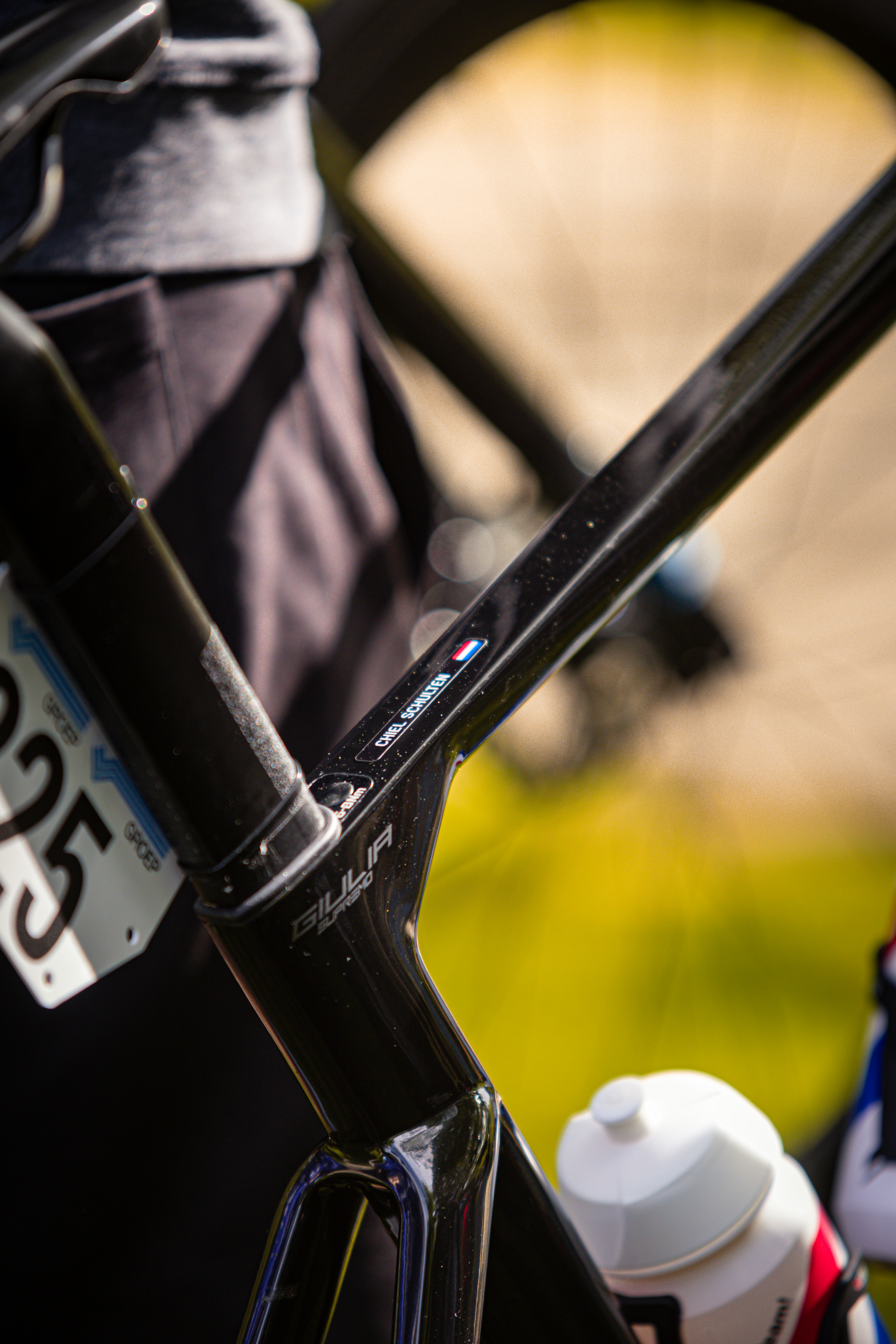 A close up of a bike handle bar attached to a frame. A 2024 license plate is visible on the frame.