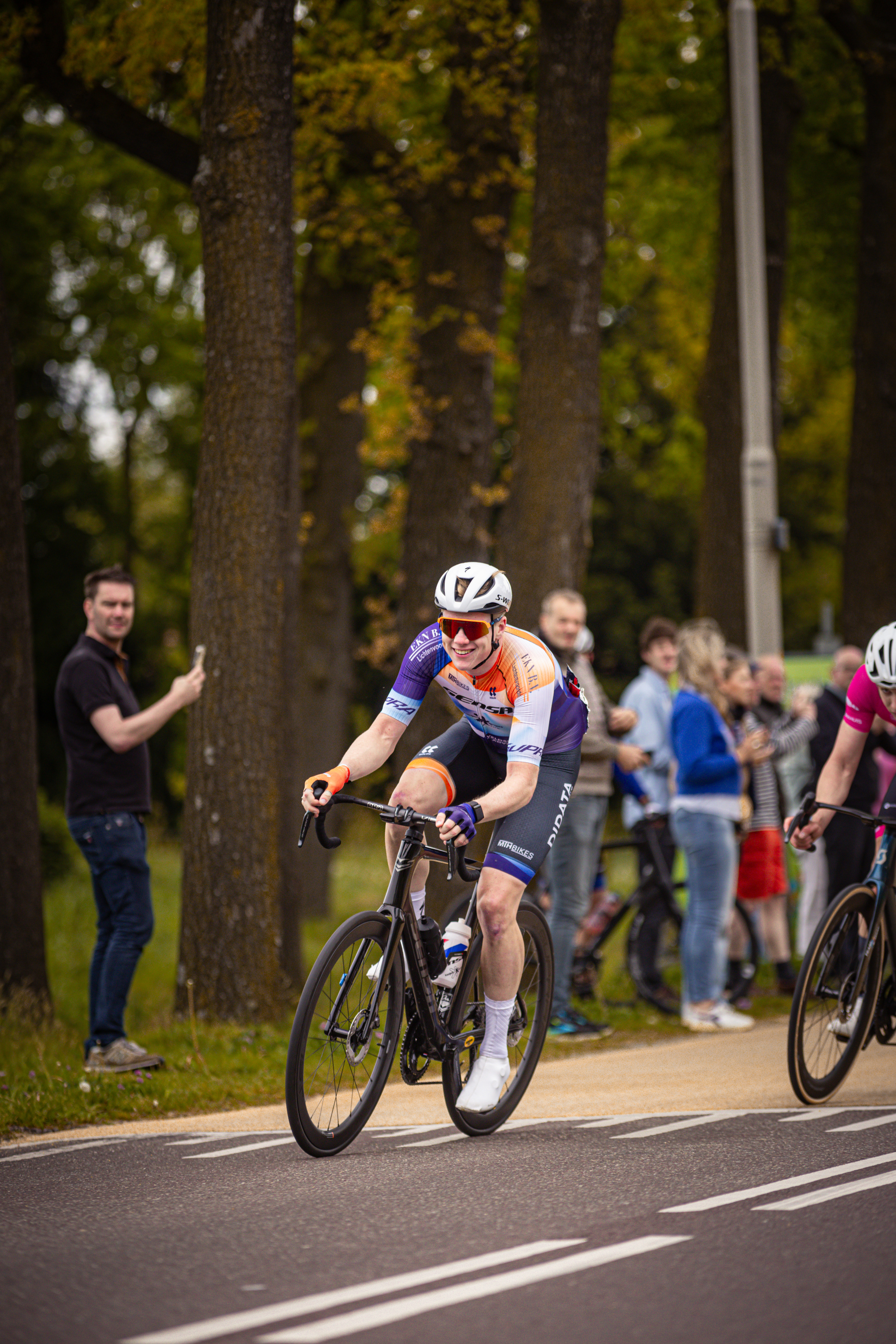 Two cyclists race down a street during the Ronde van Overijssel.