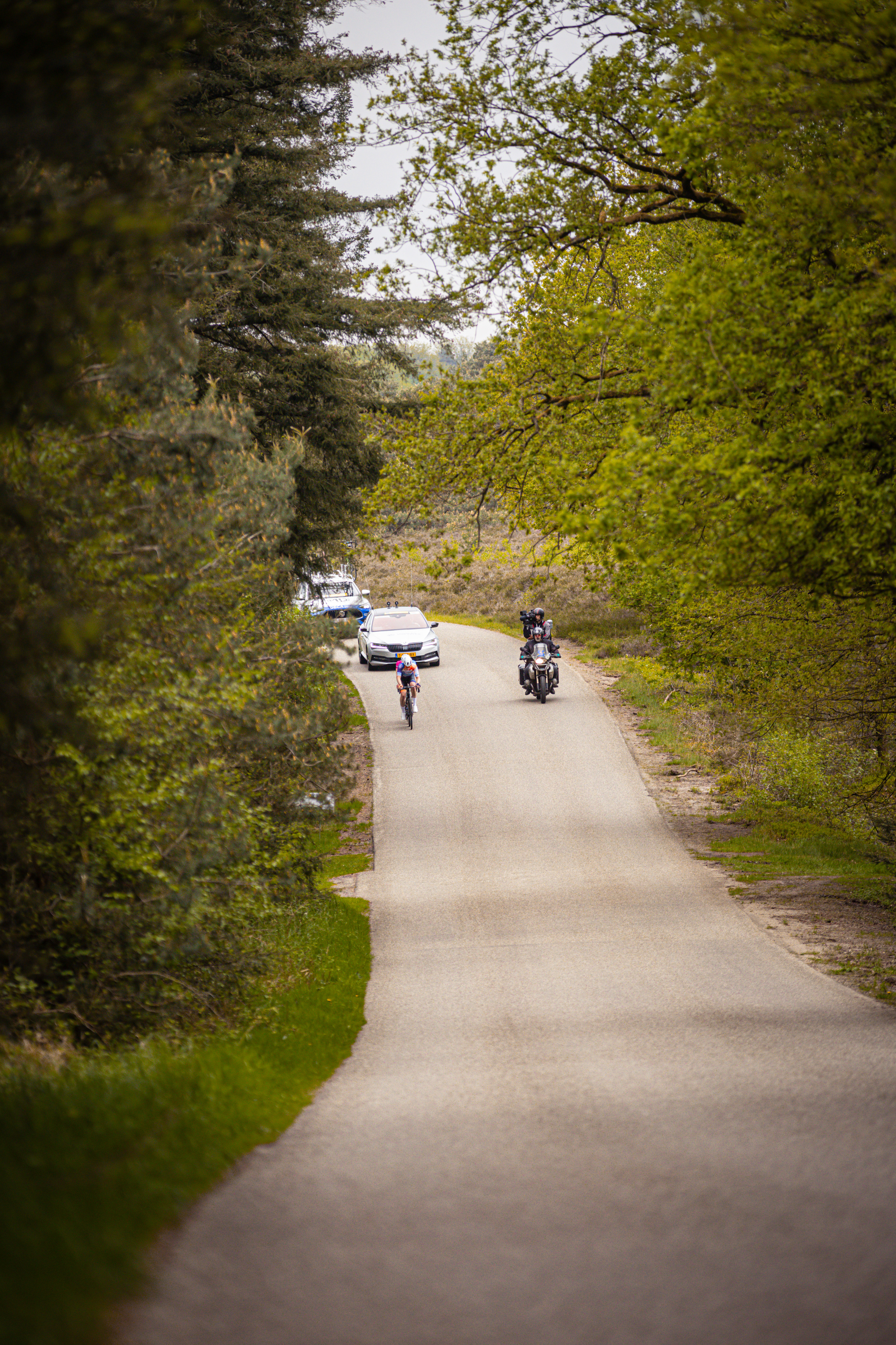 Two cyclists are riding their bikes on a road, as they compete in the 2014 Tour de France.