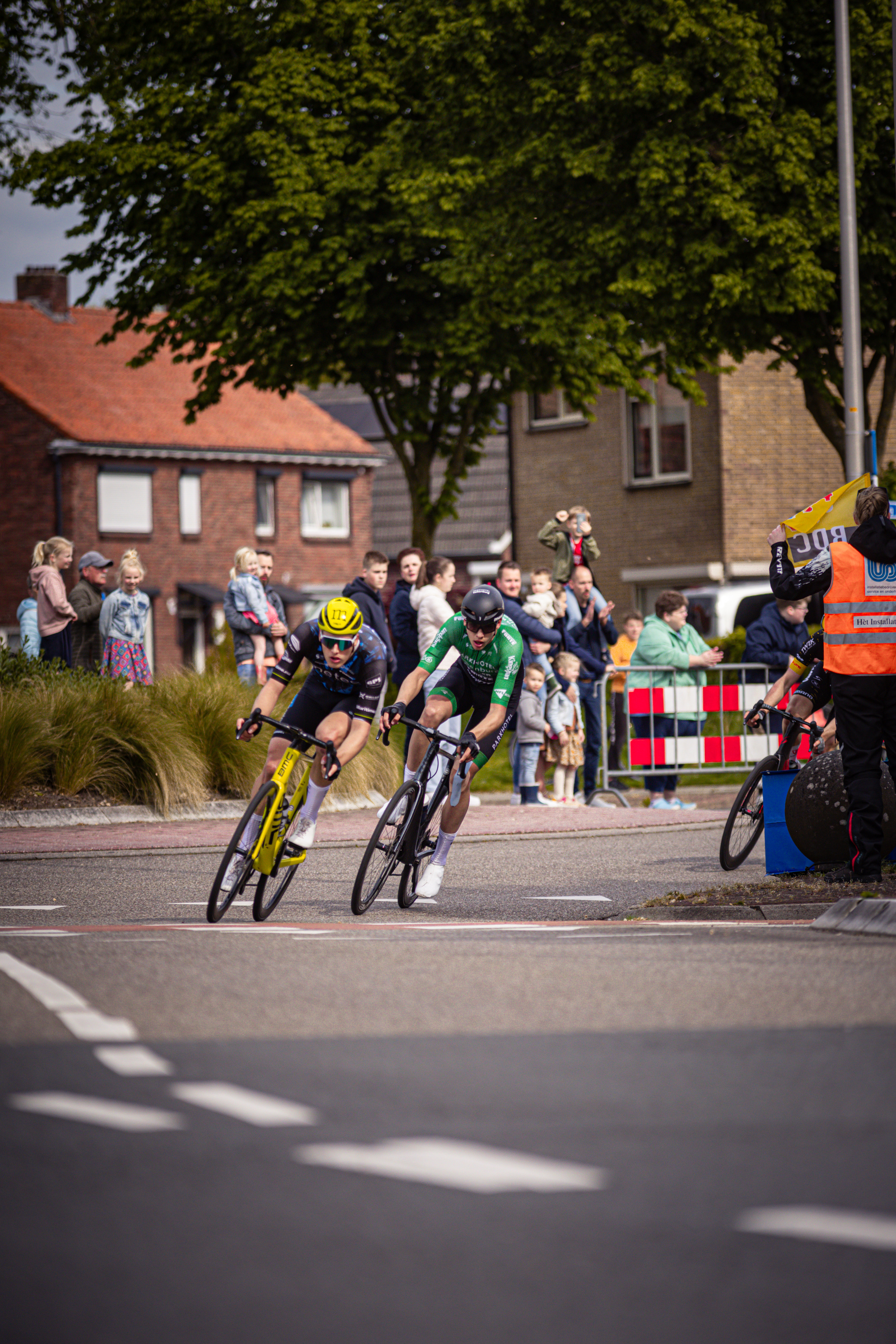 A cycling race taking place in 2024 with a crowd of people watching.