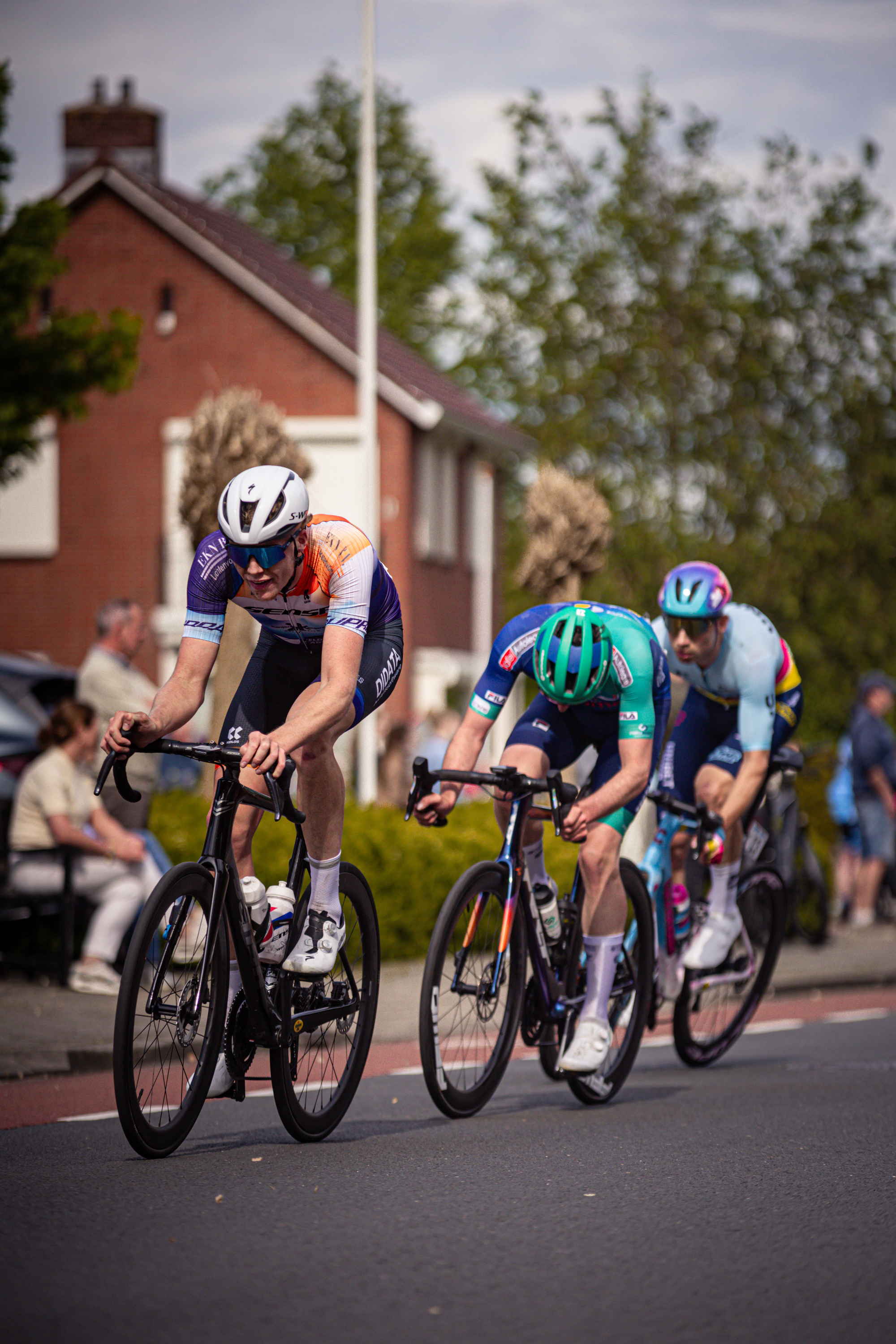 A group of cyclists race down the street during the Ronde Van Overijssel.