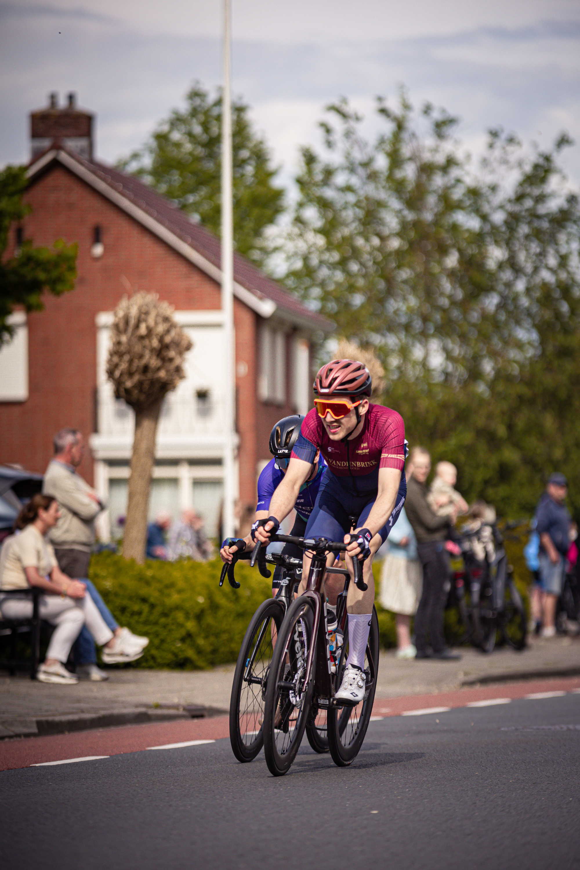 A woman is cycling on a street, the image was taken in 2024.