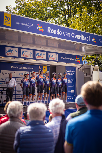 People gathered around a blue sign that reads "Ronde van Overijssel".