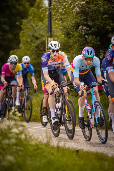 A group of cyclists race down a road during the Rode van Overijssel.