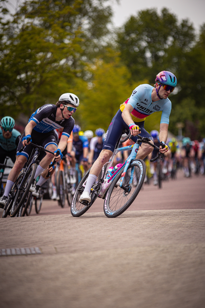 A cyclist rides on a cobblestone road near the start of the Ronde van Overijssel.