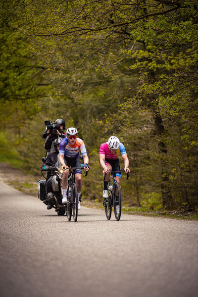 Two cyclists race down a road during the Ronde van Overijssel.