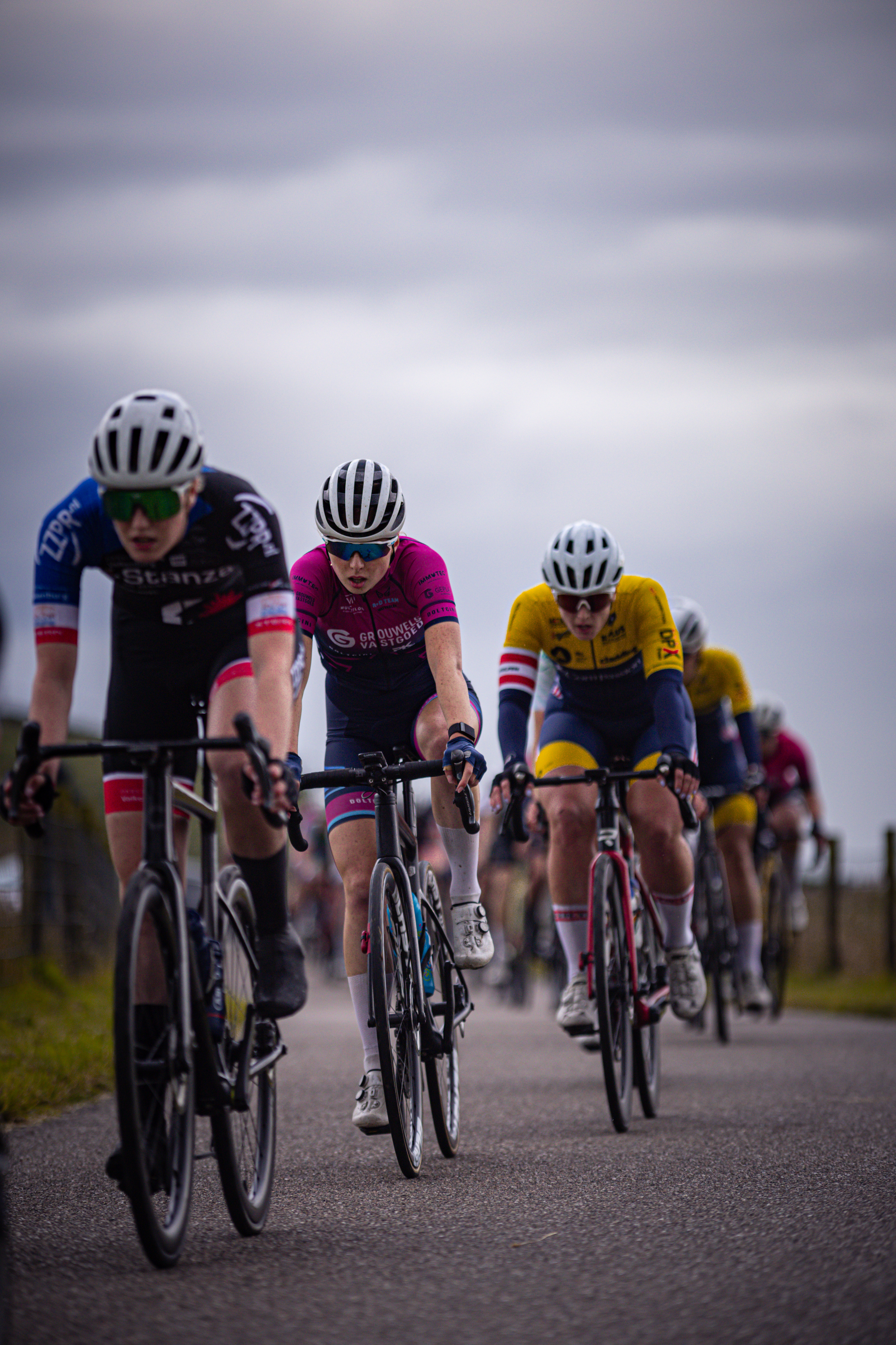 A group of cyclists participating in the 2024 Nederlands Kampioenschap, sponsored by Dames Elite ZC.