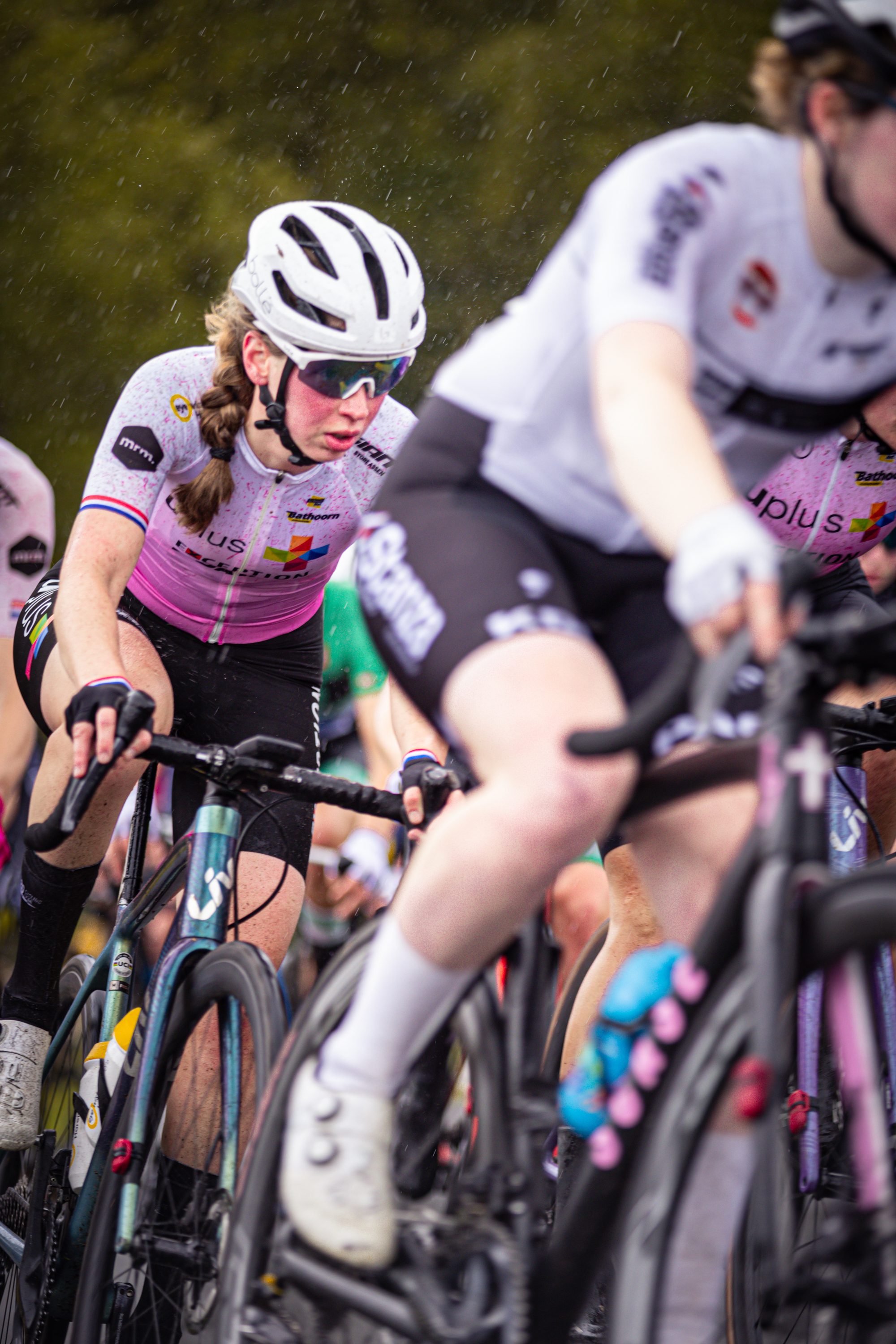 Women participating in a race, one wearing a pink shirt with 2M on it.