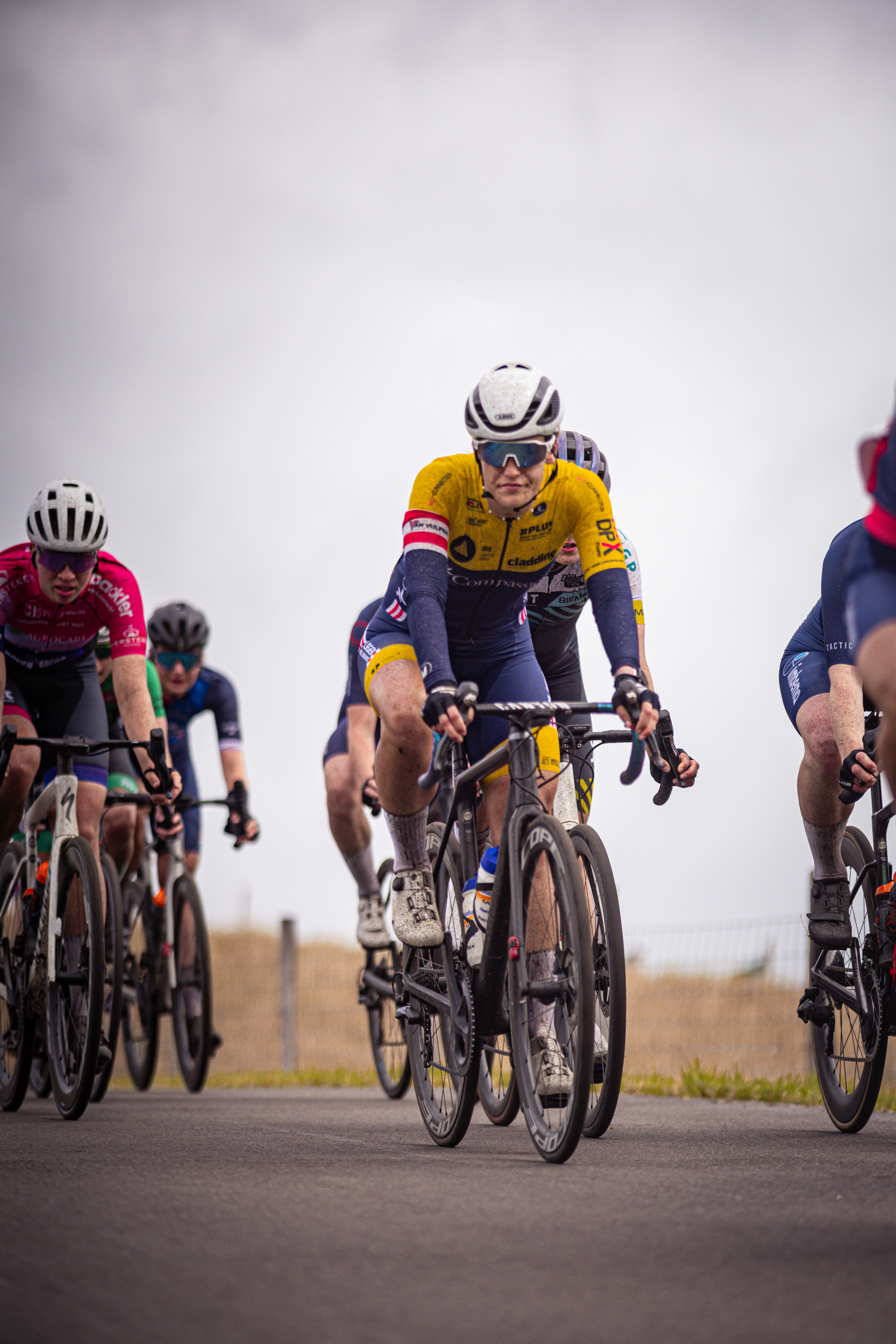 A group of cyclists are riding through a desert area.