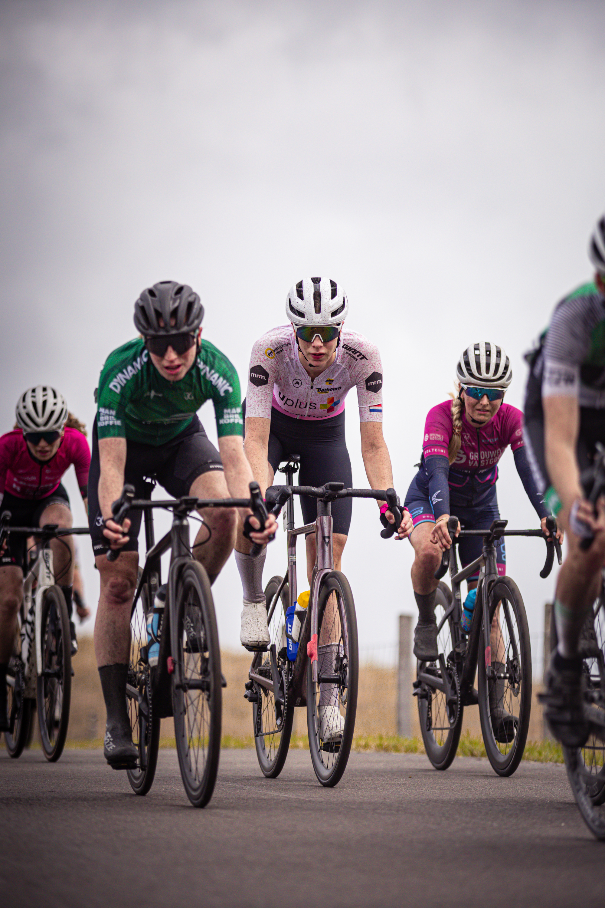 A group of cyclists from the Dames Elite ZC team are riding on a road.