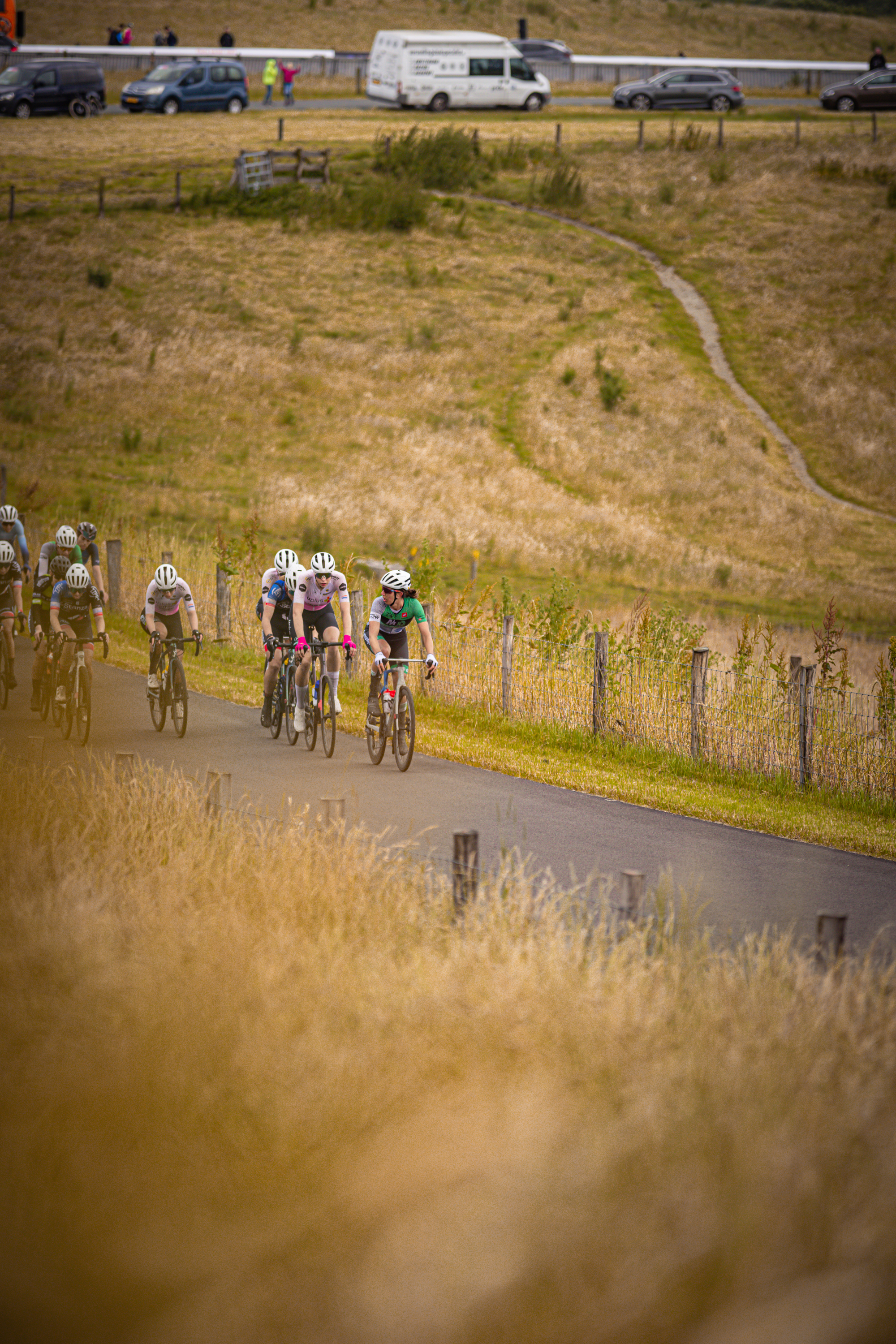 A group of cyclists race around a bend in a track during the Nederlands Kampioenschap.