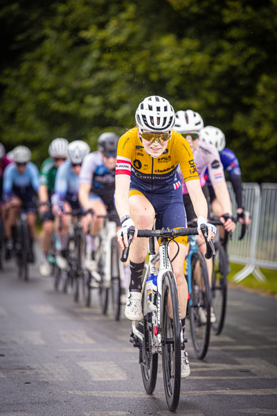 A group of bicyclists participating in a race on a sunny day.