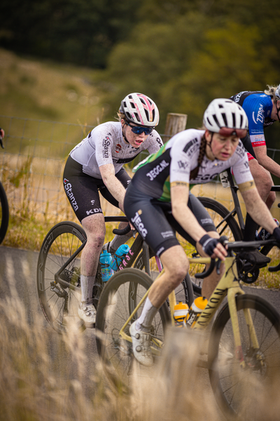 Two cyclists race against each other in a grueling competition.