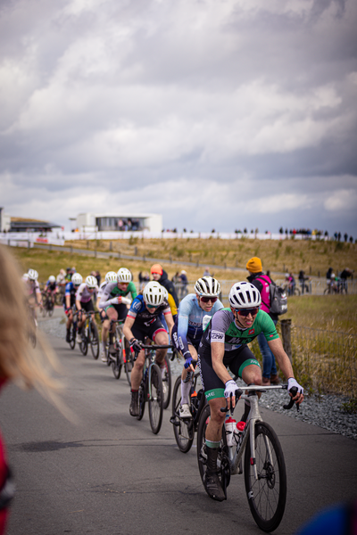 A group of cyclists in a race sponsored by Dames Elite ZC.