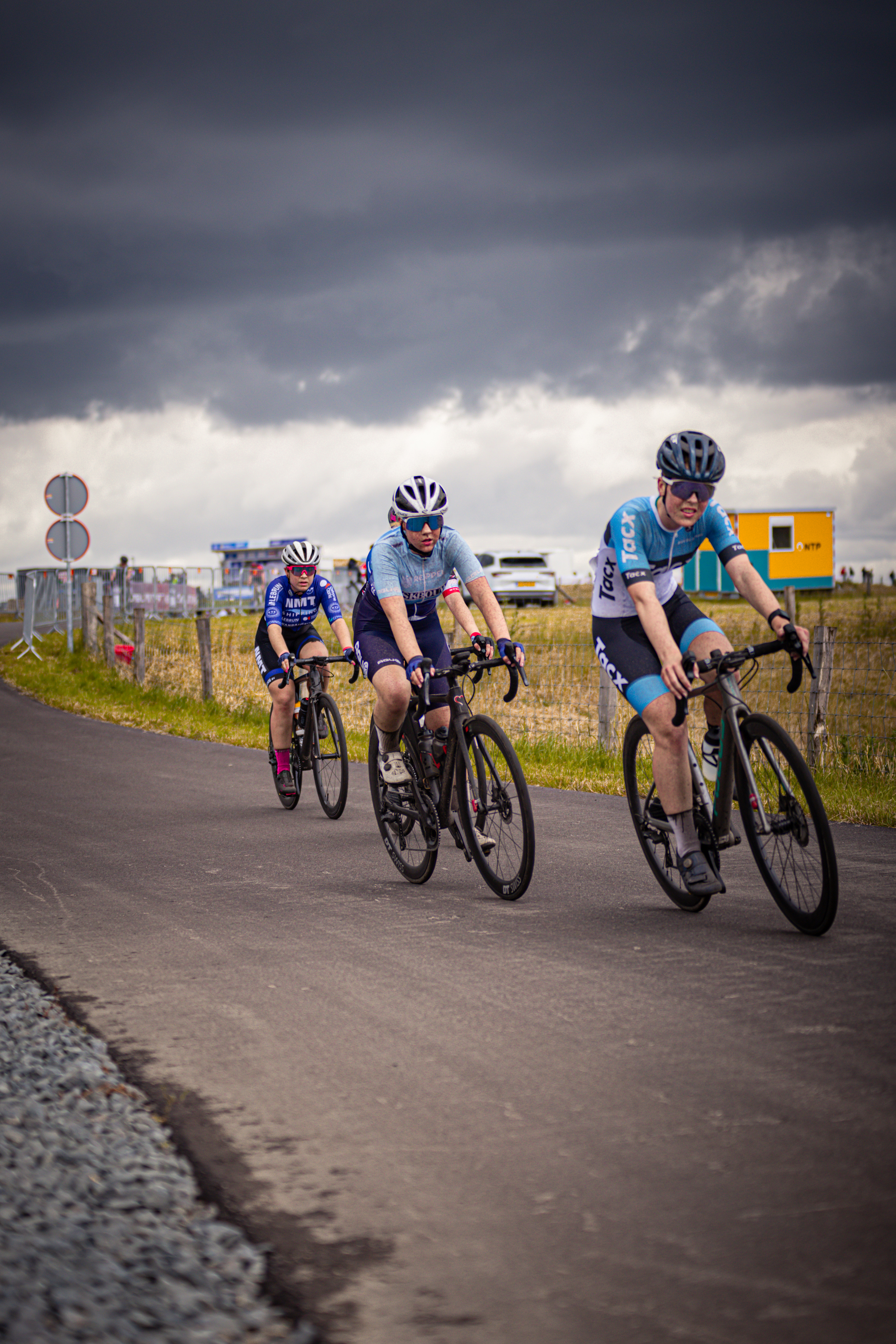 Three cyclists are participating in the Nederlands Kampioenschap.