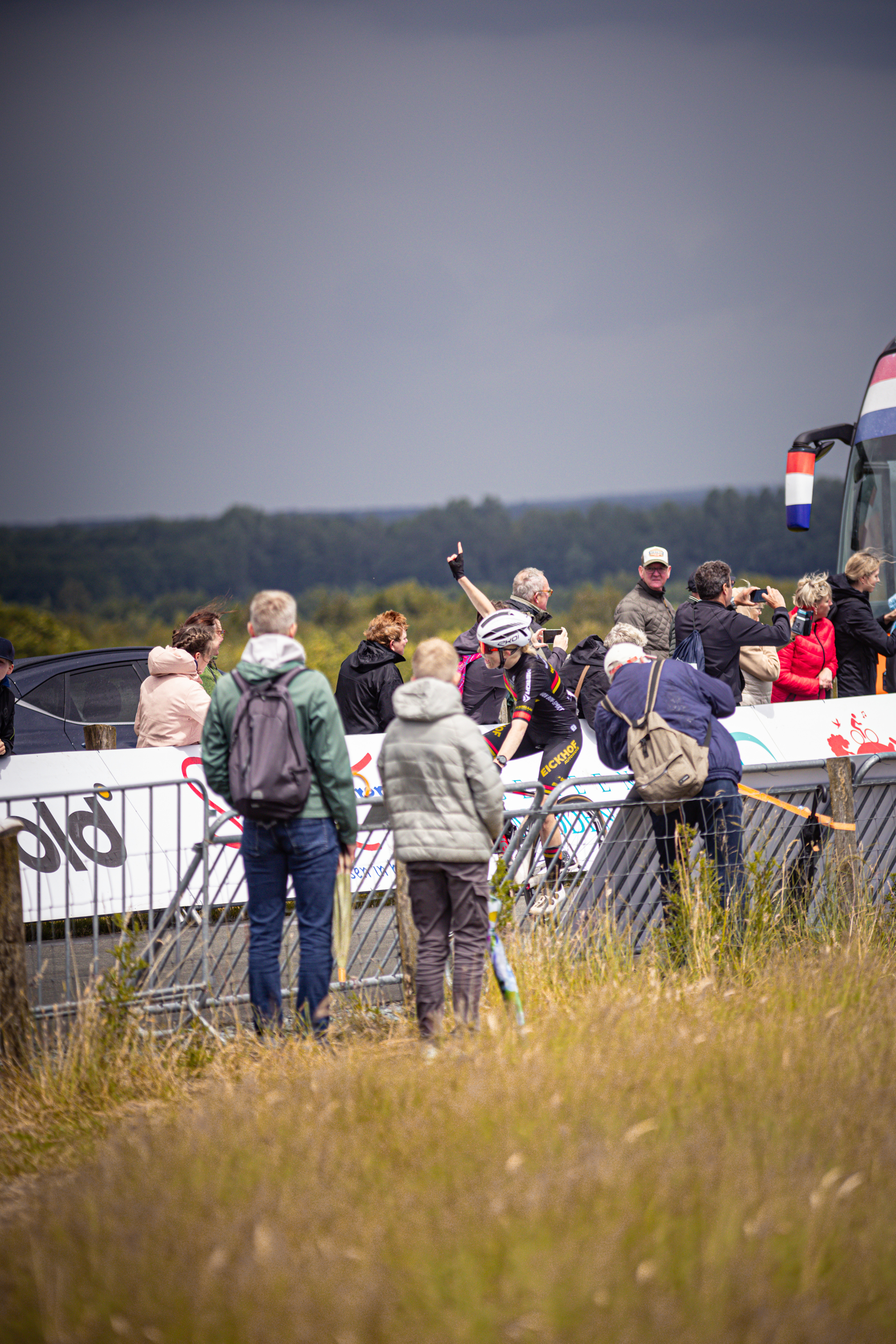 A group of people are standing around a sign for Nederlands Kampioenschap in 2024.