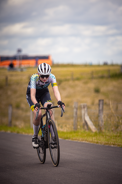 A cyclist is riding through the streets of a town.