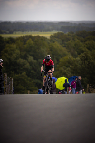 A cyclist riding on a road during the Nederlands Kampioenschap.