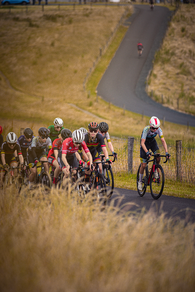 A bicycle race in progress, sponsored by the Nederlands Kampioenschap.