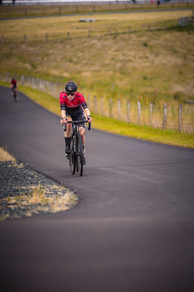 A bicycle racer is pedaling down a road during the Nederlands Kampioenschap.