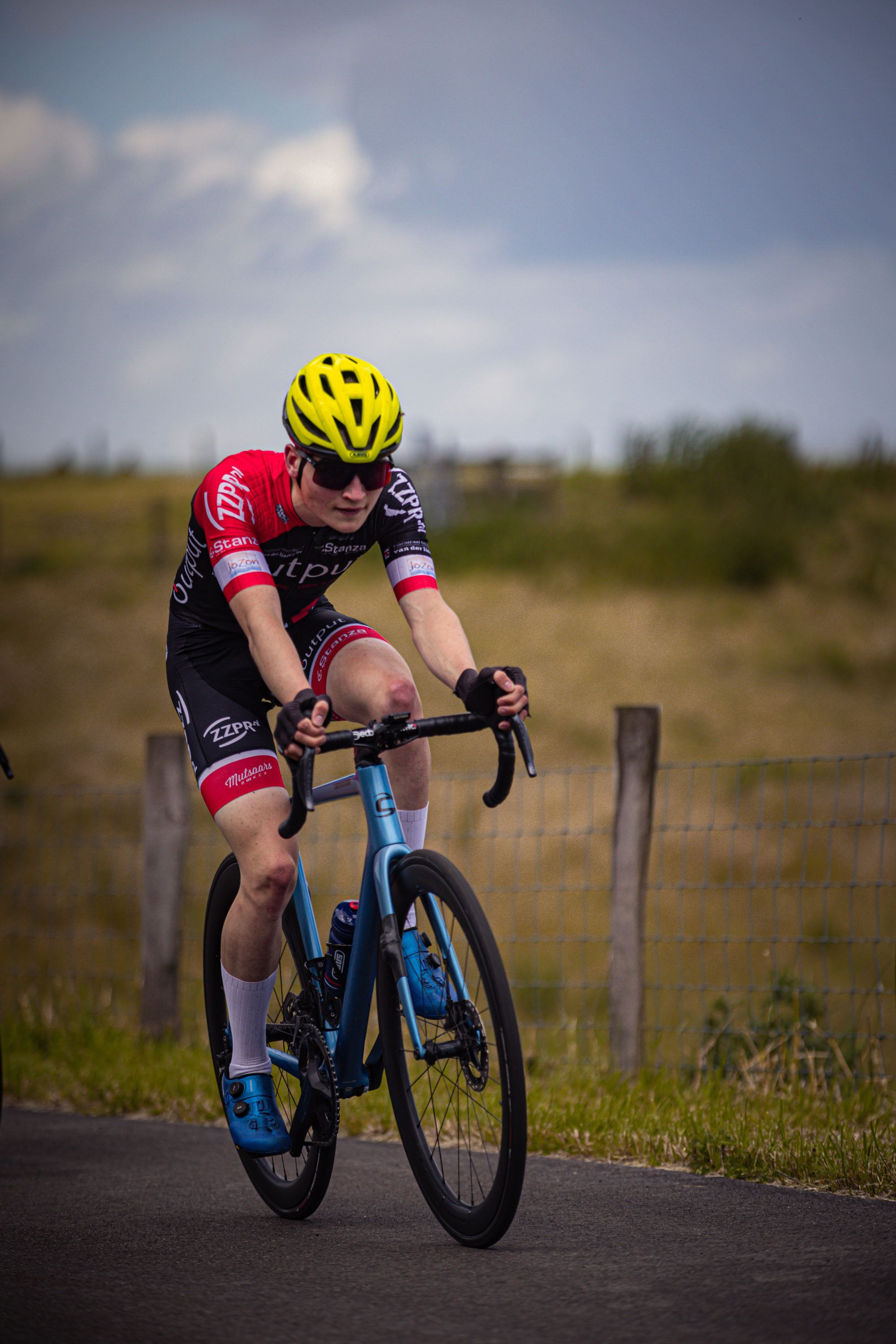 A boy on a bike that is participating in the Nederlands Kampioenschap.