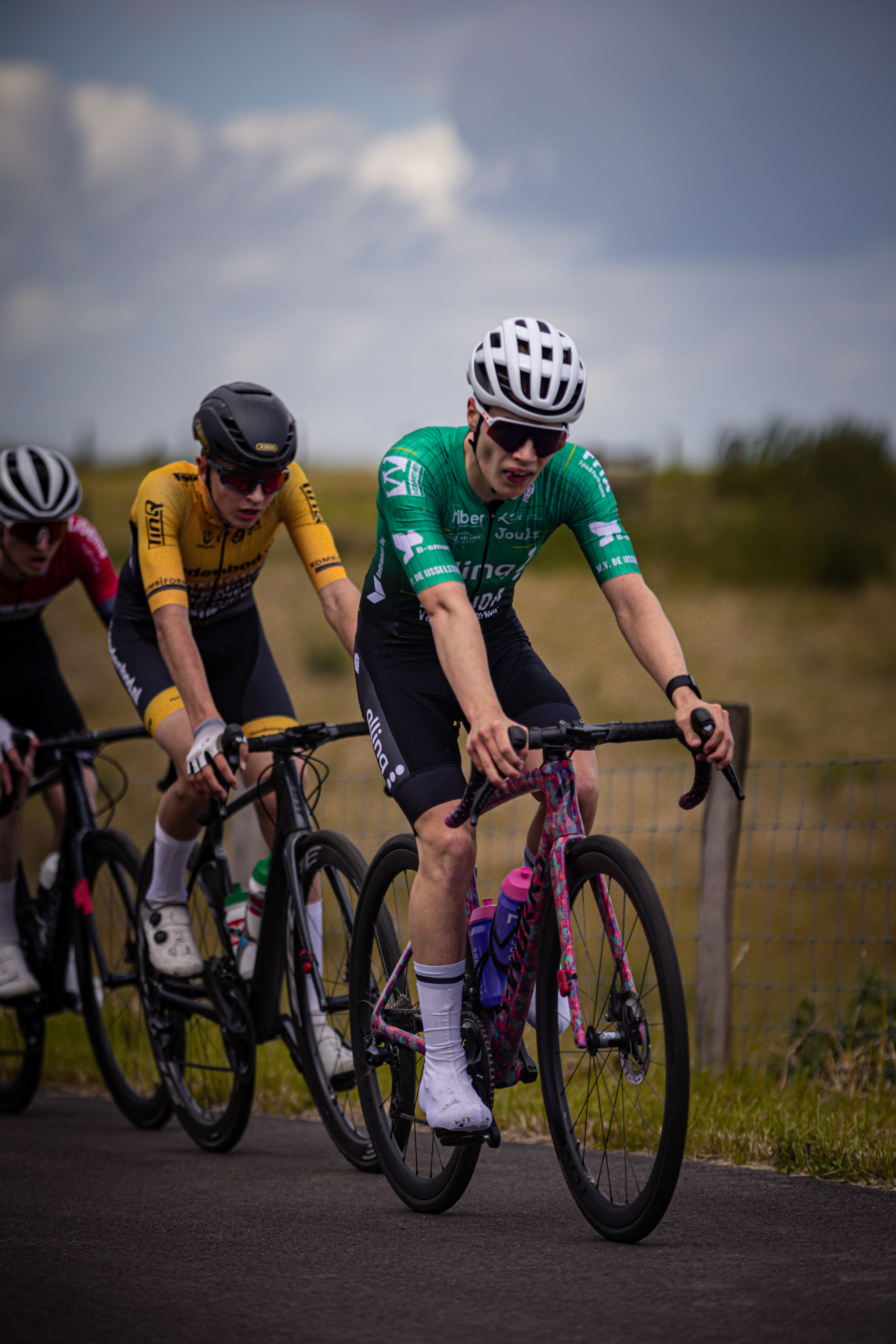 A group of bicycle racers on a track at Nederlands Kampioenschap.