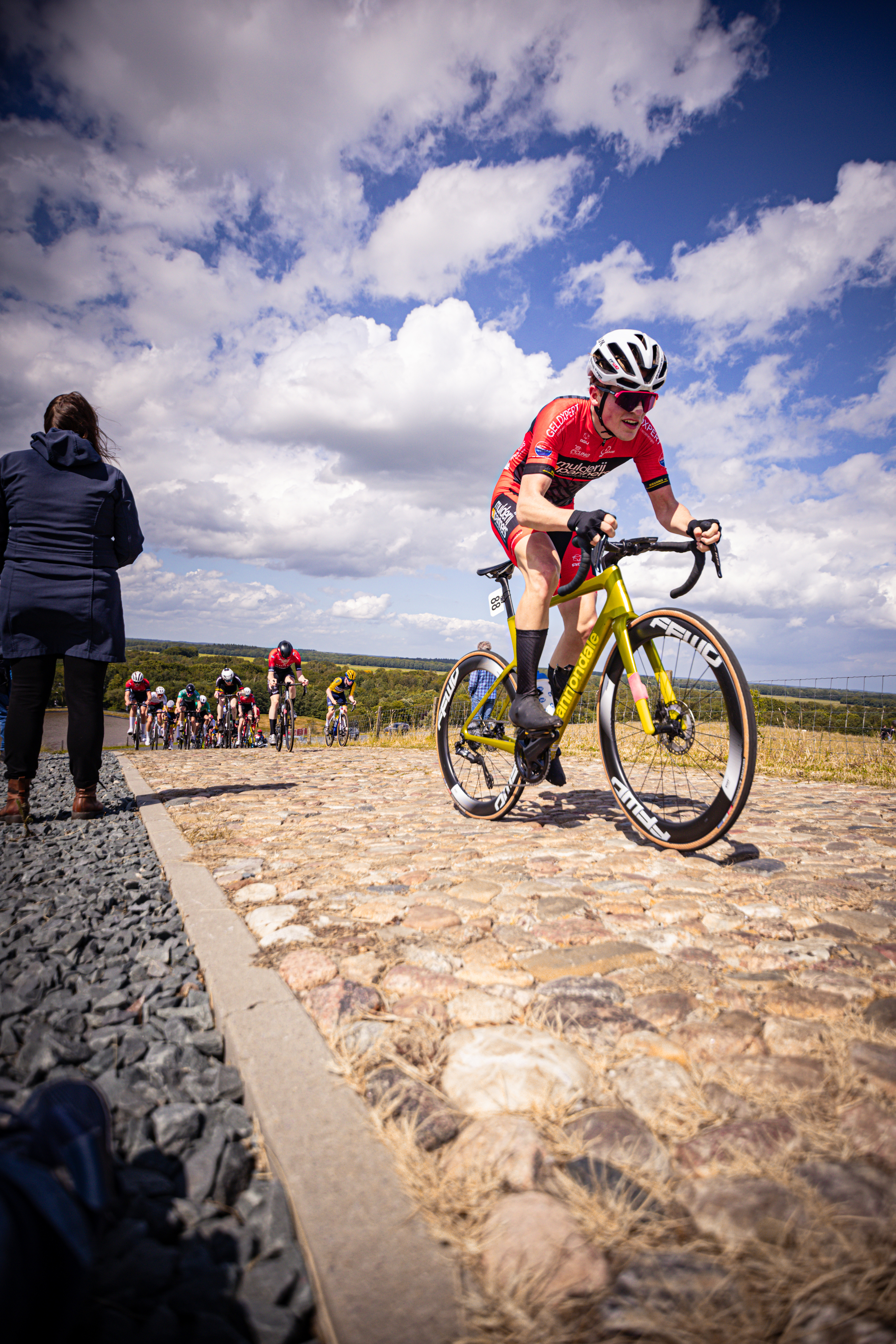 A man rides a yellow and black bike in the Nederlands Kampioenschap.