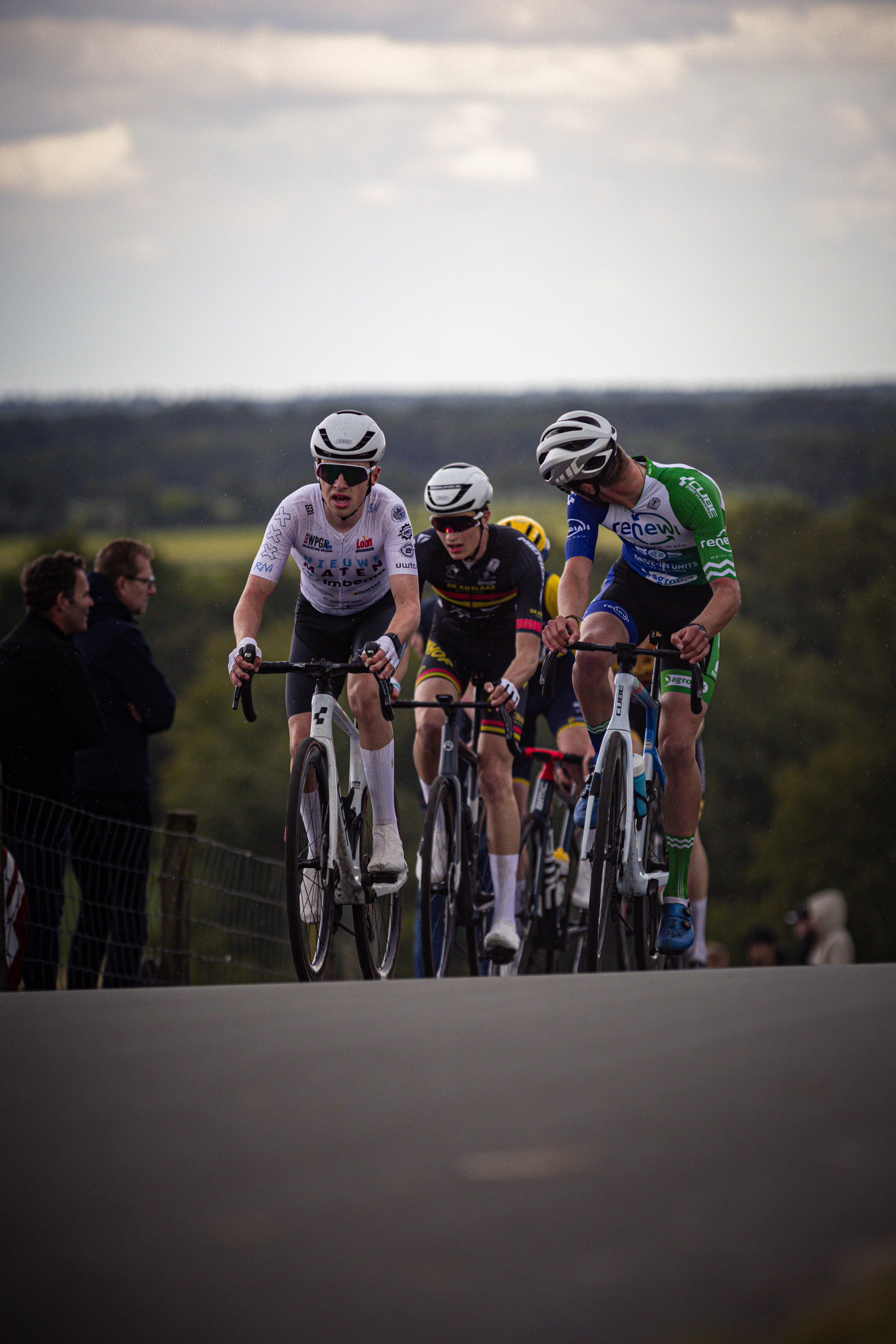 Three cyclists race at the Nederlands Kampioenschap.