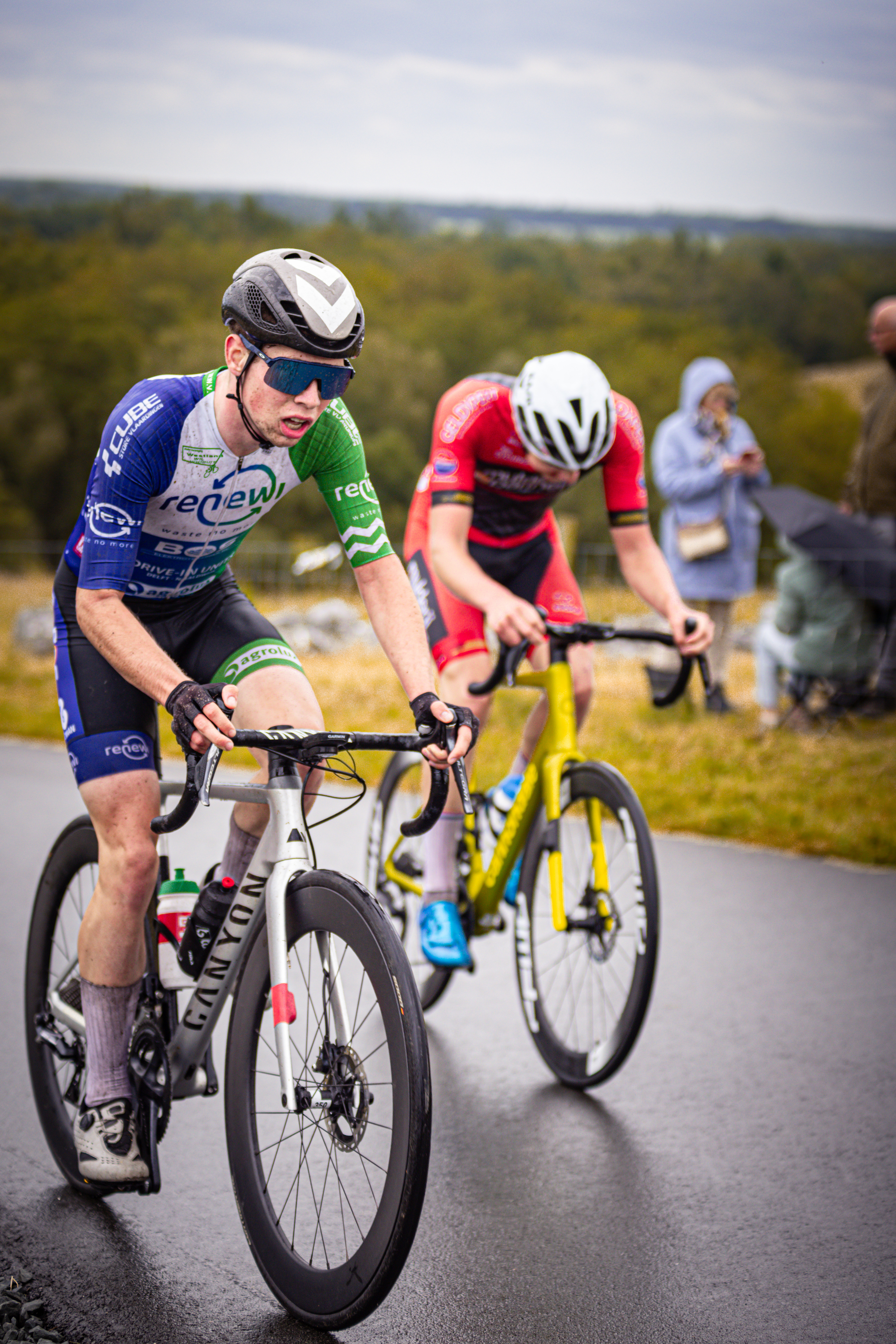 A race of two bicycle racers with one man in the lead.