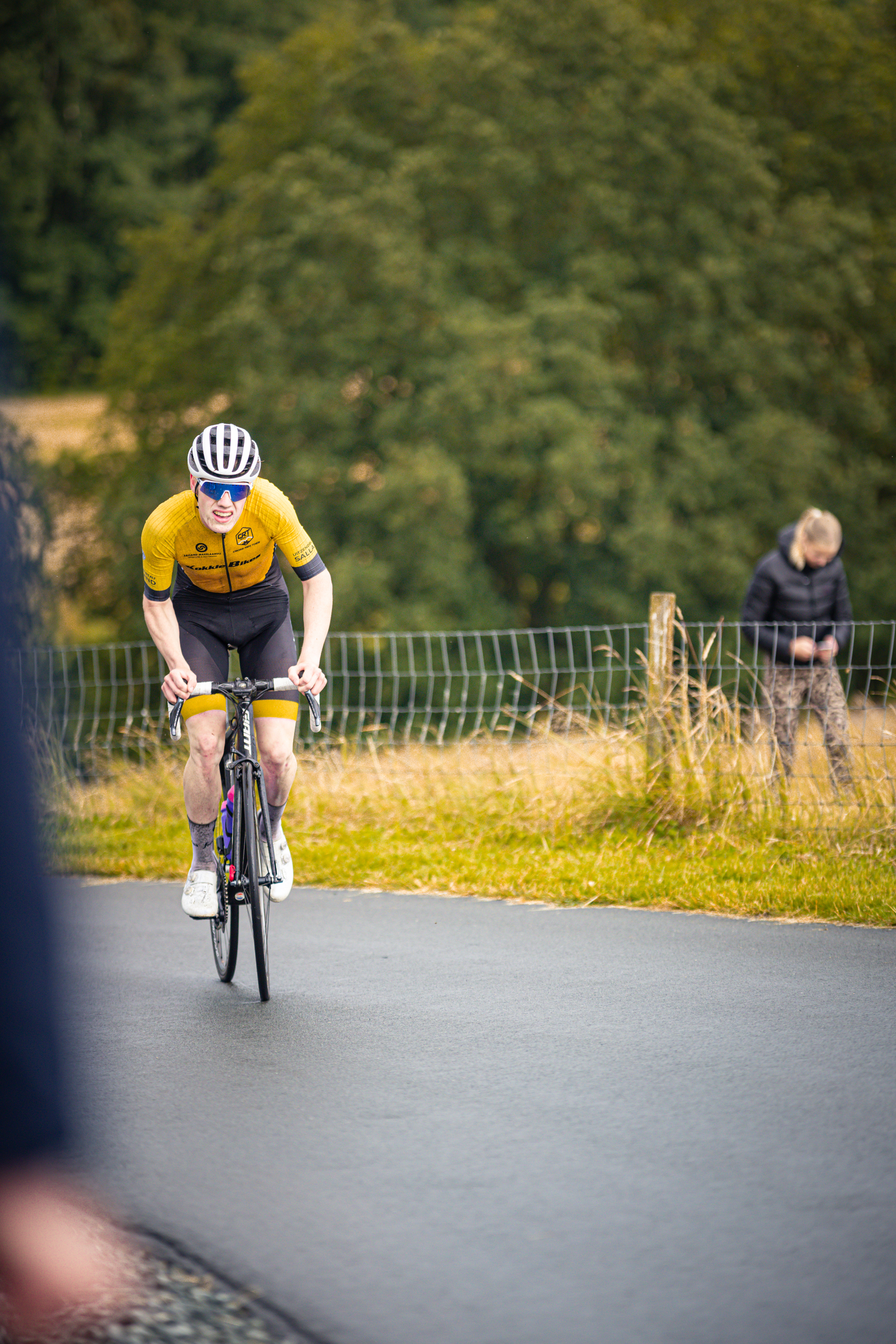 A man on a bicycle with the number 22 on his back.