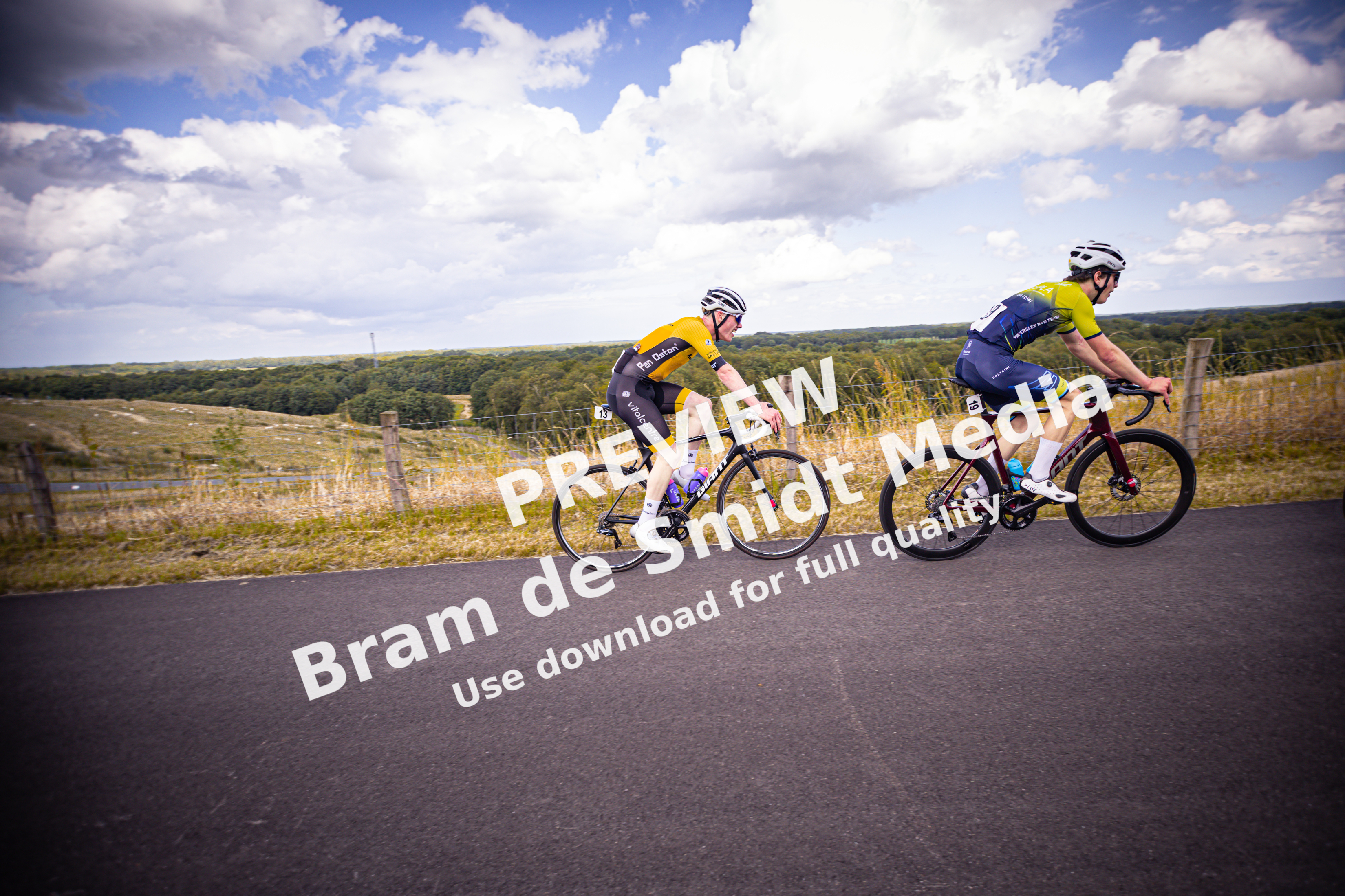 Two cyclists race down a hill during the Nederlands Kampioenschap, Junoren Mannen event.