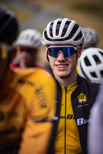 A young man wearing a yellow shirt with the word "Bieke" on it is smiling for the camera.