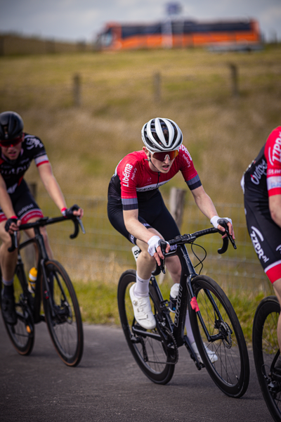 Three cyclists are racing in a race sponsored by Nike.