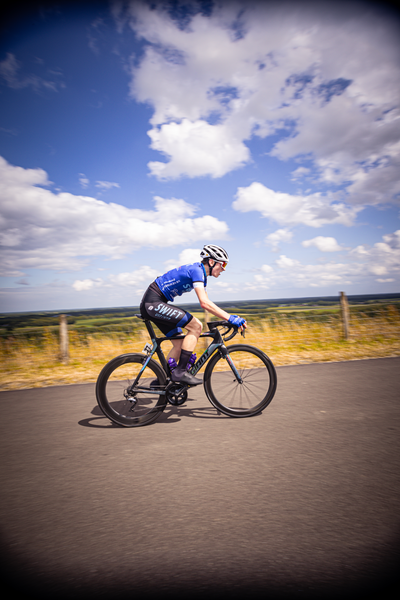 A person riding a bike with the number 7 on their back.