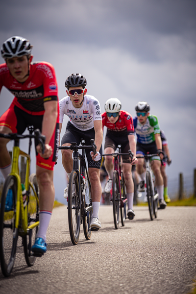 A group of cyclists race in a competitive event called the Nederlands Kampioenschap.