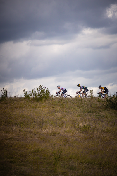 A group of cyclists are riding up a hill during the Dutch Cycling Championship.