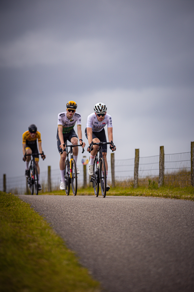 Three cyclists race down a track during the Nederlands Kampioenschap event.