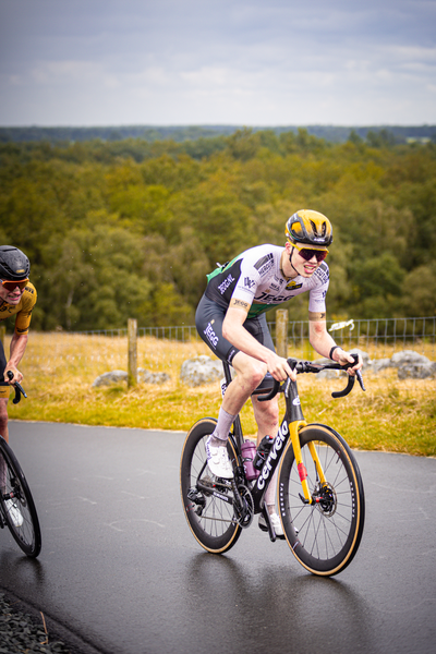 A man is racing on a bike at the Nederlands Kampioenschap Wielrennen.