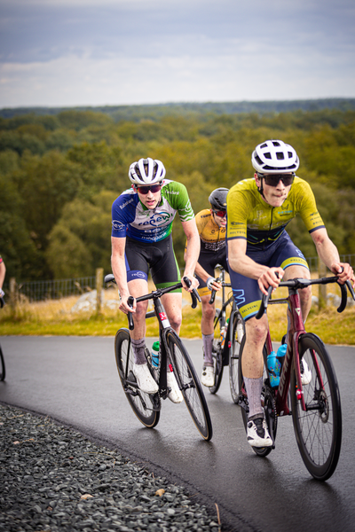 Two cyclists race down a road during the Nederlands Kampioenschap.