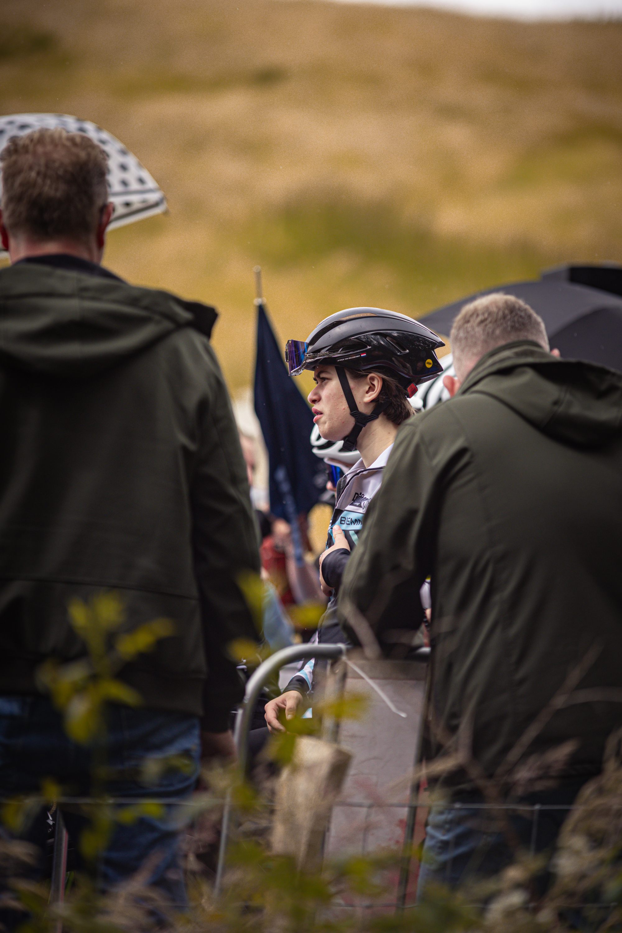 A group of cyclists wearing helmets are lined up for the Nederlands Kampioenschap.