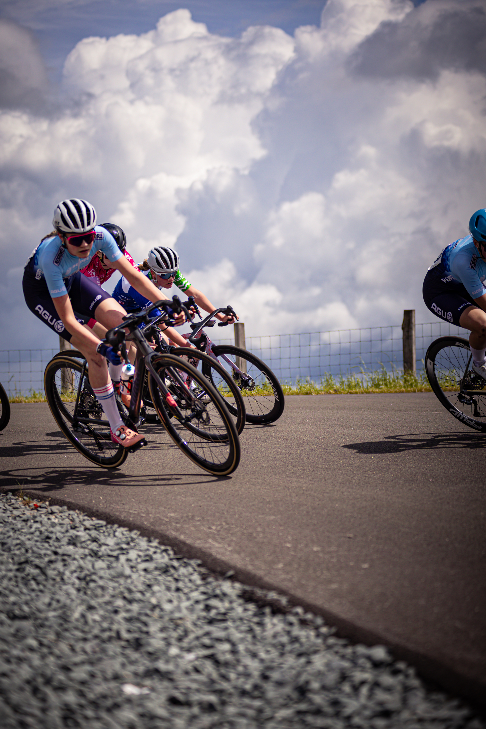 Three cyclists are racing in a competition, with one cyclist being ahead.