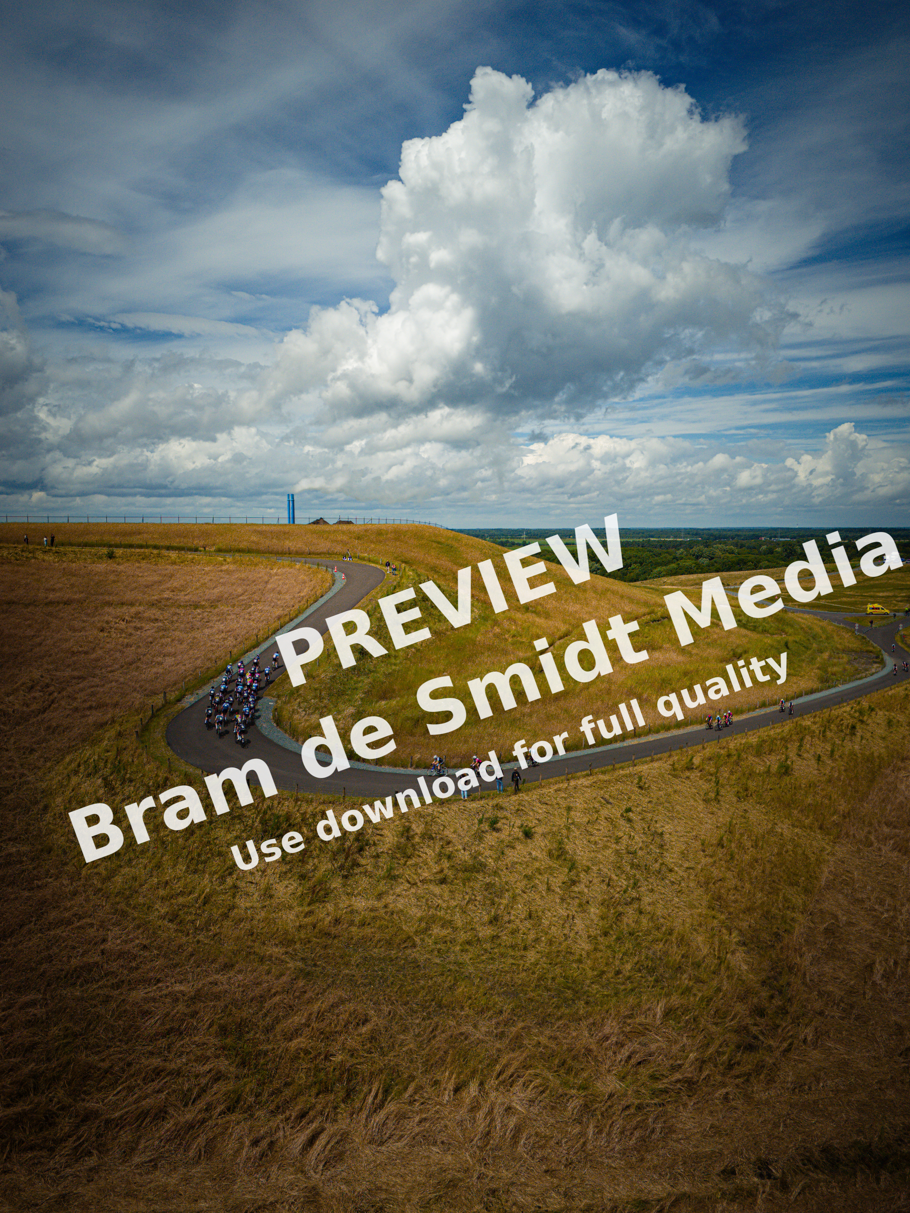 A group of people riding bikes on the side of a road.