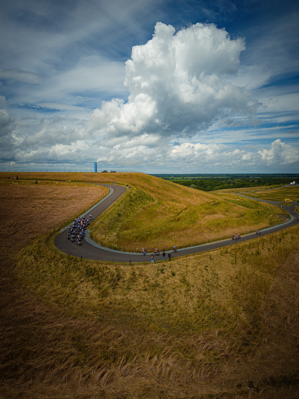 A group of people riding bikes on the side of a road.