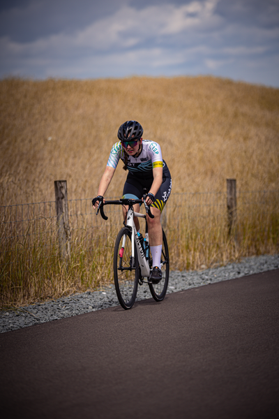 A person in a black and white helmet riding a bike.