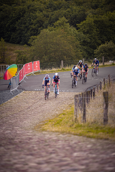 Several people on bikes are participating in a race.