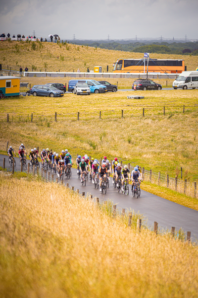 A group of cyclists riding down a road in the Netherlands.