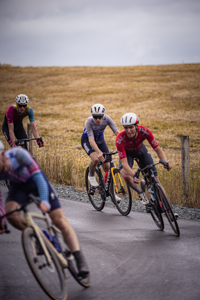 A group of cyclists in the Netherlands with two riders wearing helmets.