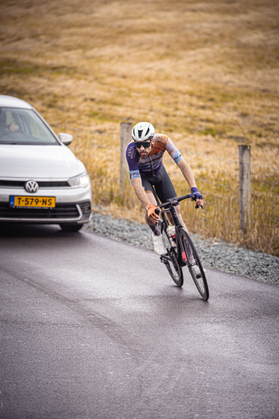 A man is on his bike racing in the 2024 Nederlands Kampioenschap.