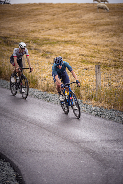 Two cyclists on a road with number 1 in the front.