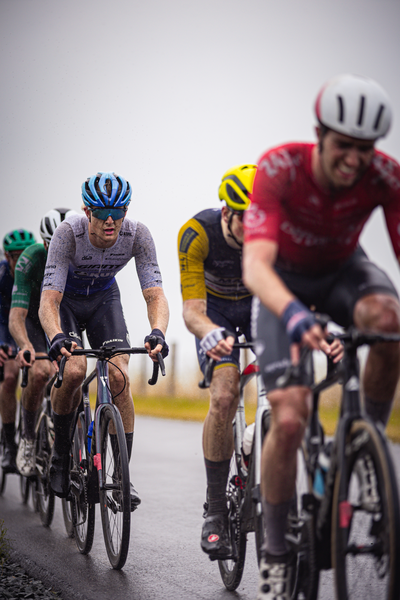 A group of cyclists compete in a race during the Nederlands Kampioenschap.